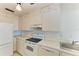 Bright kitchen with white cabinetry and appliances, offering a clean and efficient cooking space at 5400 Gulf Dr # 35, Holmes Beach, FL 34217