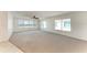 Bright, expansive living room featuring ocean views and neutral carpeting and wall paint at 5400 Gulf Dr # 35, Holmes Beach, FL 34217