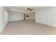 Expansive living room with neutral tones, ceiling fan, and adjacent tiled kitchen area at 5400 Gulf Dr # 35, Holmes Beach, FL 34217