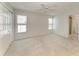 Spacious bedroom with large windows for natural light, a ceiling fan, and access to an en-suite bathroom at 5400 Gulf Dr # 35, Holmes Beach, FL 34217