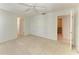 Bedroom with ceiling fan and access to en-suite bathroom showcases carpeted floors and neutral walls at 5400 Gulf Dr # 35, Holmes Beach, FL 34217