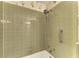 Shower featuring tile surround, shower head, and grab bar at 5400 Gulf Dr # 35, Holmes Beach, FL 34217