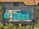 Aerial view of the backyard pool and patio area, enclosed with a screen and featuring an umbrella at 5656 Cantucci St, Nokomis, FL 34275