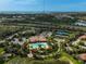 Aerial view of the community clubhouse, pool, tennis courts, playground and surrounding landscaping at 5656 Cantucci St, Nokomis, FL 34275