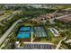 Aerial view showcases the community tennis and bocce courts next to the highway at 5656 Cantucci St, Nokomis, FL 34275