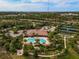 Aerial view showcasing the pool, tennis courts, clubhouse, and lush landscaping in a community setting at 5656 Cantucci St, Nokomis, FL 34275