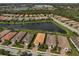 Aerial view of the neighborhood featuring the house, lake and lush landscaping at 5656 Cantucci St, Nokomis, FL 34275