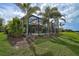 The fenced backyard features a pool, patio furniture, and beautiful landscaping at 5656 Cantucci St, Nokomis, FL 34275