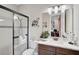 Bright bathroom featuring granite counters, modern fixtures, and a glass-enclosed shower at 5656 Cantucci St, Nokomis, FL 34275