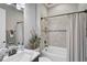 Cozy bathroom with a shower and tub combination, neutral color scheme and decor, and a vanity with a mirror at 5656 Cantucci St, Nokomis, FL 34275