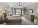 Spacious bedroom showcasing tray ceilings, crown molding, a ceiling fan, and a large window for ample natural light at 5656 Cantucci St, Nokomis, FL 34275