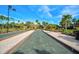 Beautiful bocce ball court bordered by lush landscaping, benches, and paver walkways at 5656 Cantucci St, Nokomis, FL 34275