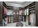 A spacious walk-in closet with custom shelving and storage solutions for clothing, shoes and other personal belongings at 5656 Cantucci St, Nokomis, FL 34275