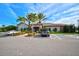 Exterior of community clubhouse with parking lot and landscaped entrance at 5656 Cantucci St, Nokomis, FL 34275