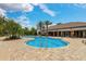 Beautiful community pool with a paved patio, palm trees, and a stylish clubhouse at 5656 Cantucci St, Nokomis, FL 34275