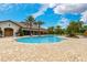 Gorgeous community pool area surrounded by lush landscaping and a modern clubhouse at 5656 Cantucci St, Nokomis, FL 34275
