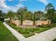 Stone community entrance sign that reads Bellacina by Casey Key, with vibrant landscaping at 5656 Cantucci St, Nokomis, FL 34275