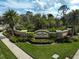 Beautifully landscaped community entrance showcasing lush greenery and an elegant community sign at 5656 Cantucci St, Nokomis, FL 34275