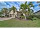 Charming exterior of a one story home with a brick driveway and lush landscaping at 5656 Cantucci St, Nokomis, FL 34275