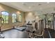 Bright gym featuring modern exercise equipment, natural light, and sleek black flooring at 5656 Cantucci St, Nokomis, FL 34275