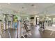 Well-equipped gym with treadmills, weight machines, mirrors, and natural light at 5656 Cantucci St, Nokomis, FL 34275
