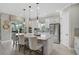 Bright kitchen featuring stainless steel appliances, large center island, and stylish pendant lighting at 5656 Cantucci St, Nokomis, FL 34275