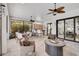 Expansive screened lanai boasts a built-in bar, dining area, comfortable seating and views of the lush landscaping at 5656 Cantucci St, Nokomis, FL 34275