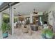 Expansive screened lanai boasts a built-in bar, dining area, comfortable seating and views of the lush landscaping at 5656 Cantucci St, Nokomis, FL 34275