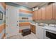 Well-organized laundry room with cabinetry, folding counter, and modern washer and dryer at 5656 Cantucci St, Nokomis, FL 34275