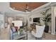 Open-concept living room with modern furnishings, a unique ceiling and seamless flow into the kitchen and dining areas at 5656 Cantucci St, Nokomis, FL 34275
