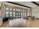 Spacious lounge area with large windows, hardwood floors, and comfortable seating at 5656 Cantucci St, Nokomis, FL 34275