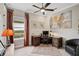 Home office with a dark wood desk, a comfortable chair, a ceiling fan and natural light from the window at 5656 Cantucci St, Nokomis, FL 34275