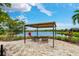 Tranquil outdoor seating area overlooking a lake and lush landscaping at 5656 Cantucci St, Nokomis, FL 34275