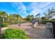 Community playground with equipment and a safety surface under a blue sky at 5656 Cantucci St, Nokomis, FL 34275