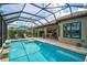 Enclosed pool with lounge chairs, beautiful tile and covered patio at 5656 Cantucci St, Nokomis, FL 34275