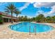 Resort-style pool featuring a zero entry and views of the palm trees and clubhouse at 5656 Cantucci St, Nokomis, FL 34275