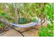 Relax in the shade of the lush, landscaped backyard with a colorful hammock at 5708 Holmes Blvd, Holmes Beach, FL 34217