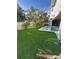 Beautiful backyard with an artificial grass and a pool, perfect for outdoor entertainment and relaxation at 5708 Holmes Blvd, Holmes Beach, FL 34217