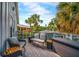 Comfortable outdoor seating on a wood balcony, ideal for enjoying the views and palm trees at 5708 Holmes Blvd, Holmes Beach, FL 34217