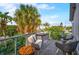 Charming balcony with comfortable seating and lush tropical views, perfect for outdoor relaxation at 5708 Holmes Blvd, Holmes Beach, FL 34217