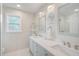 Stylish bathroom features a double vanity, modern mirrors, and abundant counter space at 5708 Holmes Blvd, Holmes Beach, FL 34217