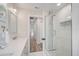 Bright bathroom with patterned shower tile, and open sight-lines to living space at 5708 Holmes Blvd, Holmes Beach, FL 34217