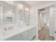 The bathroom has double sinks, modern lighting and access to a walk-in shower at 5708 Holmes Blvd, Holmes Beach, FL 34217