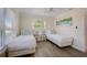 Bright bedroom has two beds and beach themed decorations at 5708 Holmes Blvd, Holmes Beach, FL 34217