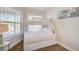 Bedroom with a white bunk bed, natural light from a window, and hardwood floors at 5708 Holmes Blvd, Holmes Beach, FL 34217