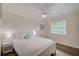 Clean bedroom boasts a white bed frame, a ceiling fan, and abundant natural light at 5708 Holmes Blvd, Holmes Beach, FL 34217