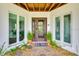 Welcoming home entrance with modern windows, a stylish door, and decorative plants for curb appeal at 5708 Holmes Blvd, Holmes Beach, FL 34217