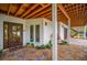 Front entrance with beautiful landscaping, featuring a wooden ceiling, a modern door, and stone accents at 5708 Holmes Blvd, Holmes Beach, FL 34217