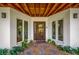 Charming entryway with decorative stone landscaping and a modern glass front door at 5708 Holmes Blvd, Holmes Beach, FL 34217