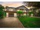 Beautifully landscaped home with a two-story design, balconies, and a well-maintained yard at 5708 Holmes Blvd, Holmes Beach, FL 34217
